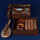 Decorative chocolate box with confections and serving utensils on a blue background