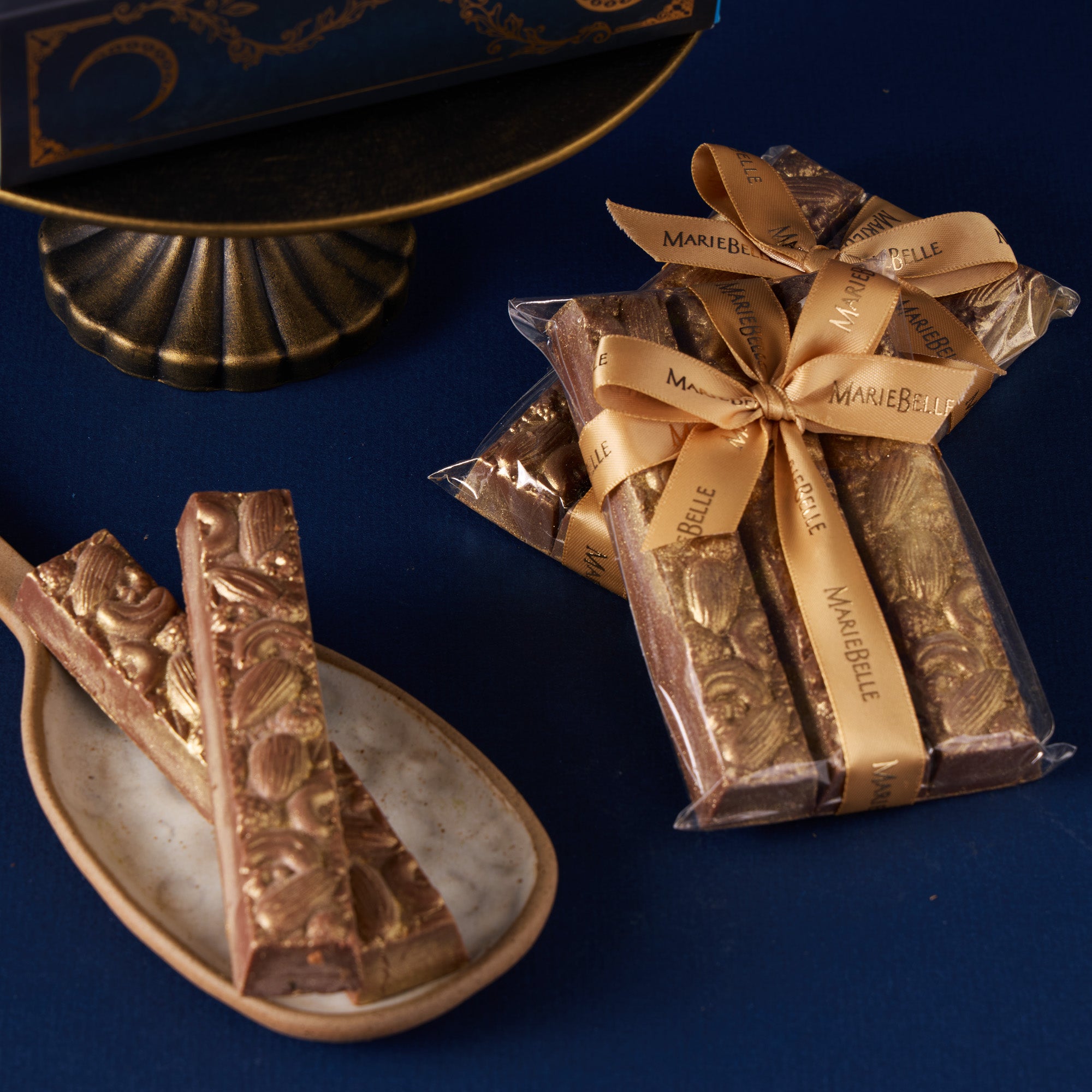 Praline chocolate bars with packaging on a blue surface